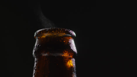 Close-Up-Of-Condensation-Droplets-On-Neck-Of-Revolving-Bottle-Of-Cold-Beer-Or-Soft-Drink-With-Water-Vapour-After-Opening-2